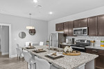 Modern kitchen in a two-bedroom apartment in Hammond with granite countertops and stainless steel appliances.