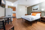 Cozy apartment featuring a flat screen TV, kitchenette, and free utilities in Baton Rouge, LA.