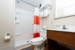 Modern bathroom in pet-friendly apartment with shower, towels, and essential amenities in Baton Rouge.
