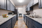 Modern kitchen with granite counters and stainless appliances in New Orleans apartment