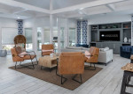 Modern lounge area in Lakeview at Palm Harbor apartments featuring stylish furniture and bright decor.