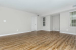 Spacious 1-bedroom apartment living room with wooden flooring in Pasadena, Maryland, featuring natural light.
