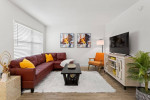 Modern living room with cozy seating and stylish decor in an apartment for rent at R U Moving.
