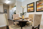 Stylish dining area in a Carrington Park apartment with modern decor and amenities.