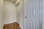 Entrance hallway featuring white walls and wood flooring, designed for Park Crescent Apartments in Washington, DC.