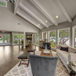 Spacious resident clubhouse with courtyard views and comfortable seating in Pinellas Park apartments.