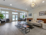Modern clubhouse interior featuring seating area and contemporary decor at Sycamores apartments in Reston, VA.