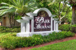 Entrance sign of The Park at Murano apartments at 4757 Barkley Circle, surrounded by lush landscaping.