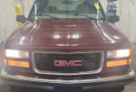 Front view of a GMC 1500 SLT truck with 89,000 miles showcasing its classic design and features.