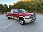 2012 Ram 3500 Mega Cab Laramie Longhorn diesel truck parked outdoors with trees in the background.