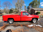 1998 Dodge Ram 1500 V6 truck with 143,698 miles, parked on a residential street with new headlights and tires.