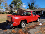 1998 Dodge Ram 1500 V6 truck parked outside, showcasing its vibrant red color and clean exterior
