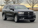 2016 Dodge Durango SXT RWD, black SUV parked outdoors, showcasing a clean exterior and smooth design.