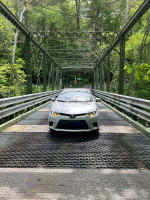 Front view of a 2016 Toyota Corolla parked on a bridge in excellent condition.