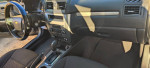 Interior view of a 2010 Ford Fusion showcasing the steering wheel and dashboard features.