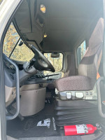 Interior view of a 2018 Freightliner 113 Day Cab, highlighting dashboard and seating area.
