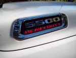 Close-up of a 2020 Ram 5500 Heavy Duty emblem on the truck's hood, showcasing its robust design.