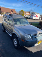 2003 Nissan Xterra in champagne color for sale, ideal for repair or parts, located in residential area.