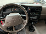 Interior view of a 1995 Toyota Tacoma with original features and aftermarket Bluetooth stereo.