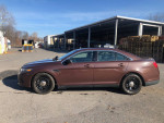 Side view of a 2015 Ford Taurus Police Package, freshly repainted with a durable exterior and police features.