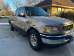 1998 Ford F150 truck with 148,000 miles, featuring a damaged front fender and cold AC.