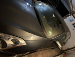 2012 Nissan Altima SL parked indoors, showing headlights and hood details.