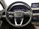 Interior view of a 2019 Audi Q7 showcasing the steering wheel and dashboard controls.