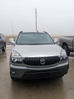 Front view of a 2007 Buick Rendezvous CXL with new parts, parked outdoors in foggy weather.