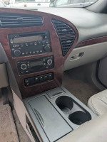 Interior view of 2007 Buick Rendezvous CXL with radio controls and cup holders