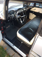 Interior view of a 1956 Chevrolet Belair 9 passenger wagon showing stylish dashboard and seating.