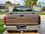 Rear view of a 2001 Dodge Ram Laramie SLT 1500 V8 truck with a toolbox and clean design.