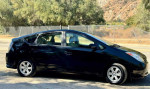 2005 Toyota Prius hatchback in black with 96,115 miles, showing sleek design and efficient performance.