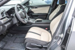 Interior view of 2018 Honda Civic EX Hatchback with black and ivory seats, showcasing modern design and features.