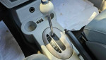 2006 Chrysler PT Cruiser interior gear shift and cup holder with gray seating and automatic transmission.