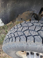Close-up of the tire tread on a 2003 Chevrolet Silverado 2500HD showing good condition and grip.