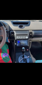 Interior view of a 2003 Infiniti G35 showcasing dashboard, controls, and gear shift
