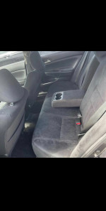 Interior view of a well-maintained 2011 Honda Accord EX with black upholstery and spacious seating.