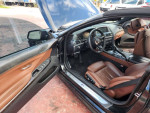 Interior view of a black 2014 BMW 6 Series 640i convertible with brown seats.