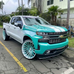 2024 Chevrolet Silverado 3500HD High Country in teal and white with custom wheels, available for sale or rental.