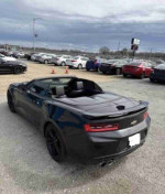 2017 Chevrolet Camaro 1LS in black, showcasing its aggressive design and sporty features in a dealership lot.