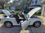 1999 Mazda MX-5 Miata Touring Package with power features, parked with hood open.