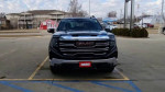 Front view of a 2023 GMC Sierra 1500 truck parked for sale, featuring a sleek design and bold GMC branding.