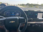 Interior view of a 2024 Chevrolet Silverado 2500HD LT, showcasing dashboard and infotainment system.