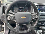 Interior view of a 2020 Chevrolet Colorado LT, showcasing the dashboard and steering wheel with low mileage.