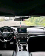 Interior view of a 2018 Honda Accord Sport showcasing dashboard, steering wheel, and infotainment system.