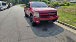 2007 Chevrolet Silverado 1500 Classic LT1 in red parked on the street, showcasing its exterior design.