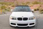 White 2013 BMW 1 Series 128i Convertible parked in a scenic outdoor area