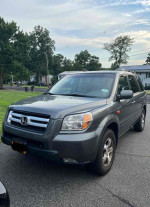 2007 Honda Pilot EX-L in fair condition, showcasing its front view in a residential area.