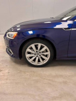 Close-up of the stylish wheel and front side of a 2018 Audi A5 in scuba blue, showcasing its premium features.