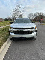 Front view of a 2019 Chevrolet Silverado 1500 parked on a residential street, showcasing its sleek design.